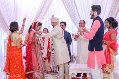Indian groom putting garland to bride. Indian groom putting garland to bride.