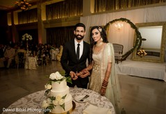 Indian wedding cutting the cake scene Indian wedding cutting the cake scene