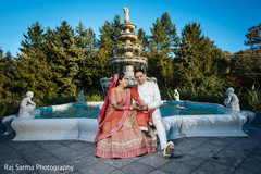Indian bride and groom posing for the photo shoot Indian bride and groom posing for the photo shoot