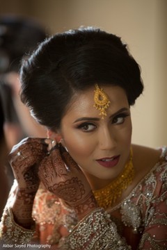 Gorgeous Indian bride putting her earrings on. Gorgeous Indian bride putting her earrings on.
