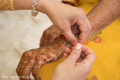 Maharani getting a bracelet at haldi. Maharani getting a bracelet at haldi.