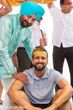 Indian groom smeared all over with turmeric paste. Indian groom smeared all over with turmeric paste.
