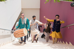 Indian groom with groomsmen dancing with dhol player. Indian groom with groomsmen dancing with dhol player.