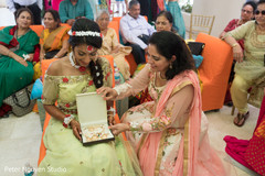 Indian bride receiving a gift at her pre-wedding party. Indian bride receiving a gift at her pre-wedding party.