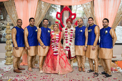 Indian bride and groom posing with groomsmen Indian bride and groom posing with groomsmen