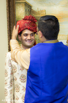 Indian groom being assisted by special guest Indian groom being assisted by special guest