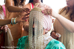 Indian groom getting the sehra on his turban. Indian groom getting the sehra on his turban.