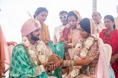 Indian bride giving the coconut to groom. Indian bride giving the coconut to groom.