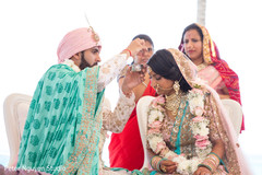 Indian groom putting the mark on maharani's forehead. Indian groom putting the mark on maharani's forehead.