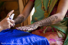 Indian bride being assisted with the mehndi Indian bride being assisted with the mehndi