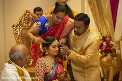 Indian bride being assisted by her family Indian bride being assisted by her family