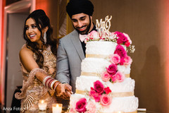 Lovely capture Indian bride and groom cutting cake together. Lovely capture Indian bride and groom cutting cake together.