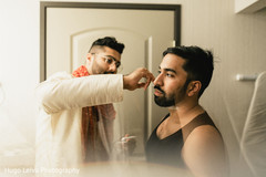 Indian groom being assisted by special guest Indian groom being assisted by special guest