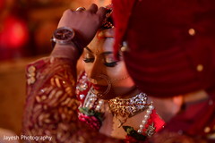 Indian groom putting the red mark on bride's forehead. Indian groom putting the red mark on bride's forehead.