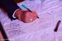 Indian wedding guest signing guest book. Indian wedding guest signing guest book.