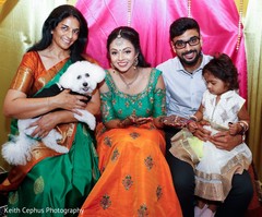 Lovely Indian bride and groom posing at mehndi party with relative. Lovely Indian bride and groom posing at mehndi party with relative.
