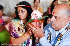 Indian relatives holding the coconut for haldi. Indian relatives holding the coconut for haldi.