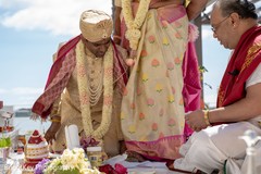 Indian couple rolling betel nut with toes. Indian couple rolling betel nut with toes.