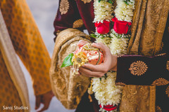 Indian groom holding the coconut at the Dwar Puja. Indian groom holding the coconut at the Dwar Puja.