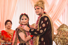 Lovely Indian couple at their jaimala ritual. Lovely Indian couple at their jaimala ritual.