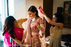 Indian bride being helped to get ready. Indian bride being helped to get ready.