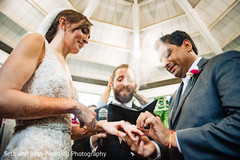 Indian groom putting ring to bride capture. Indian groom putting ring to bride capture.