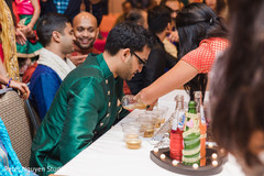 Indian groom having a drink Indian groom having a drink