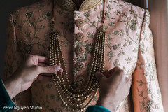 Indian groom being assisted by family member Indian groom being assisted by family member