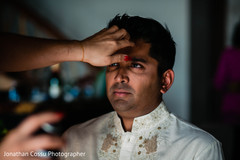 Indian groom getting his hair done for ceremony. Indian groom getting his hair done for ceremony.