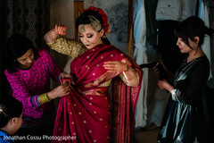 Indian bride getting help to put her sari on. Indian bride getting help to put her sari on.