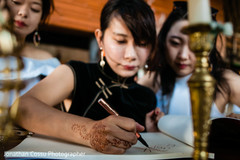 Indian wedding guest signing the guestbook. Indian wedding guest signing the guestbook.