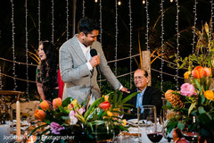 Indian groom talking to his father at reception capture. Indian groom talking to his father at reception capture.