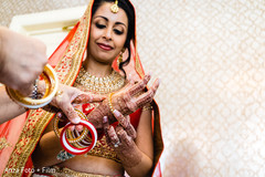 Sweet Indian bride putting her chooras on. Sweet Indian bride putting her chooras on.