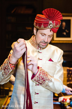 Charming Indian groom putting his dupatta on. Charming Indian groom putting his dupatta on.