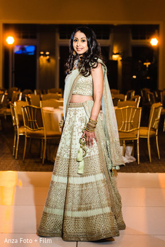 Enchanting Indian bride posing on her reception lehenga. Enchanting Indian bride posing on her reception lehenga.