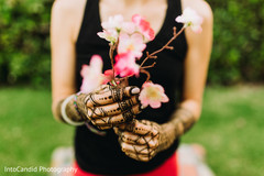 Indian bridal henna art on hands holding flowers. Indian bridal henna art on hands holding flowers.