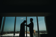 Indian groom being helped to get his sherwani. Indian groom being helped to get his sherwani.