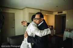 Indian groom hugging his parent . Indian groom hugging his parent .