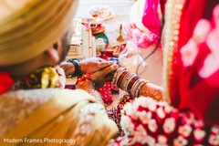 Indian groom holding bride's hands at wedding ritual. Indian groom holding bride's hands at wedding ritual.