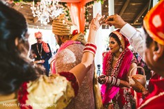 Indian bride pouring rice on to groom's ritual. Indian bride pouring rice on to groom's ritual.