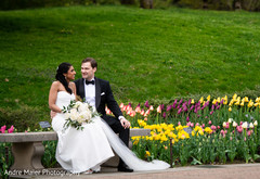 Bride and groom having a tender moment by the flowers Bride and groom having a tender moment by the flowers