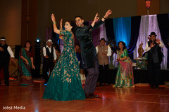 Indian couple dancing at sangeet party. Indian couple dancing at sangeet party.