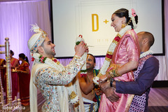 Indian groom putting garland to bride at a pre-wedding ritual. Indian groom putting garland to bride at a pre-wedding ritual.