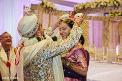 Indian groom putting garland to bride photo. Indian groom putting garland to bride photo.