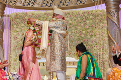 Indian groom putting flower garland to bride. Indian groom putting flower garland to bride.