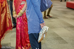 Indian guest holding Indian grooms wedding shoes. Indian guest holding Indian grooms wedding shoes.