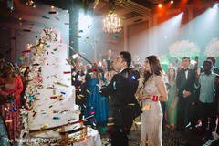 Incredible Indian bride and groom cutting cake moment. Incredible Indian bride and groom cutting cake moment.