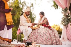 Indian groom putting wedding ring on bride Indian groom putting wedding ring on bride