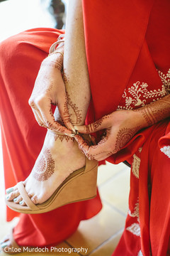Indian bride putting her shoes on. Indian bride putting her shoes on.