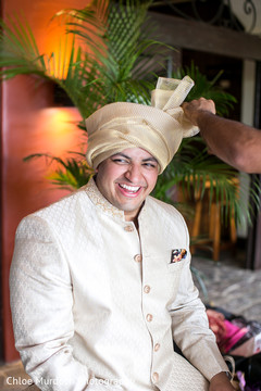 Charming Indian groom getting his turban on. Charming Indian groom getting his turban on.